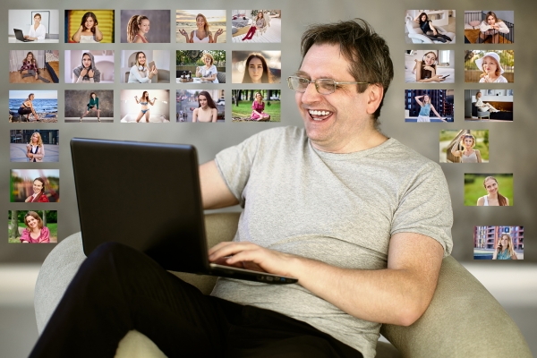 middle aged man smiling online dating on laptop