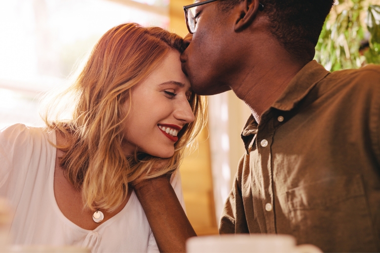 dating young couple black man kissing forehead of white girl
