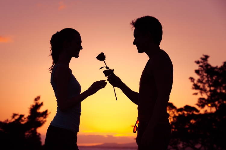 young boy presenting flower on first date